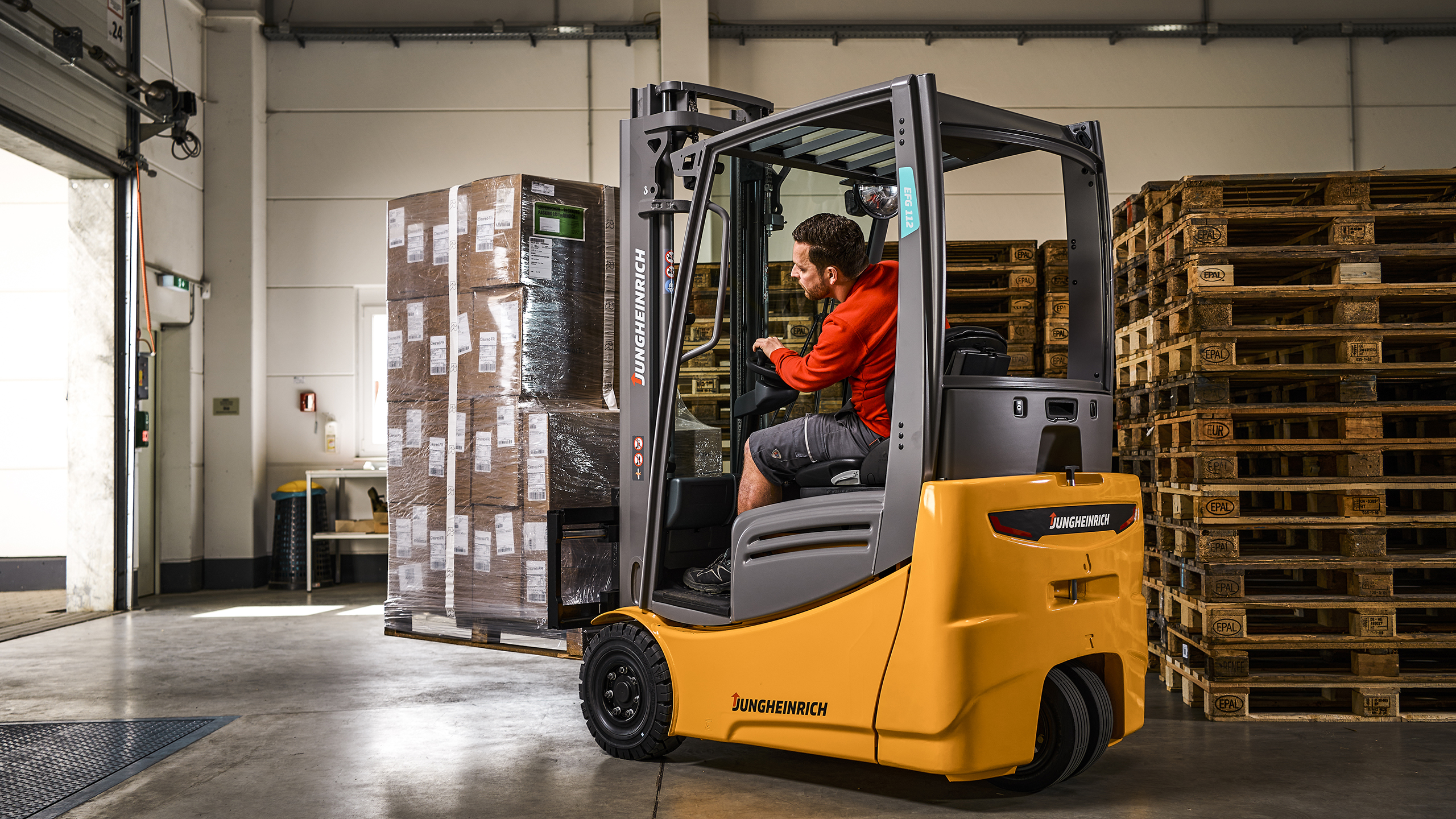 A forklift truck transports several boxes in the fulfillment warehouse