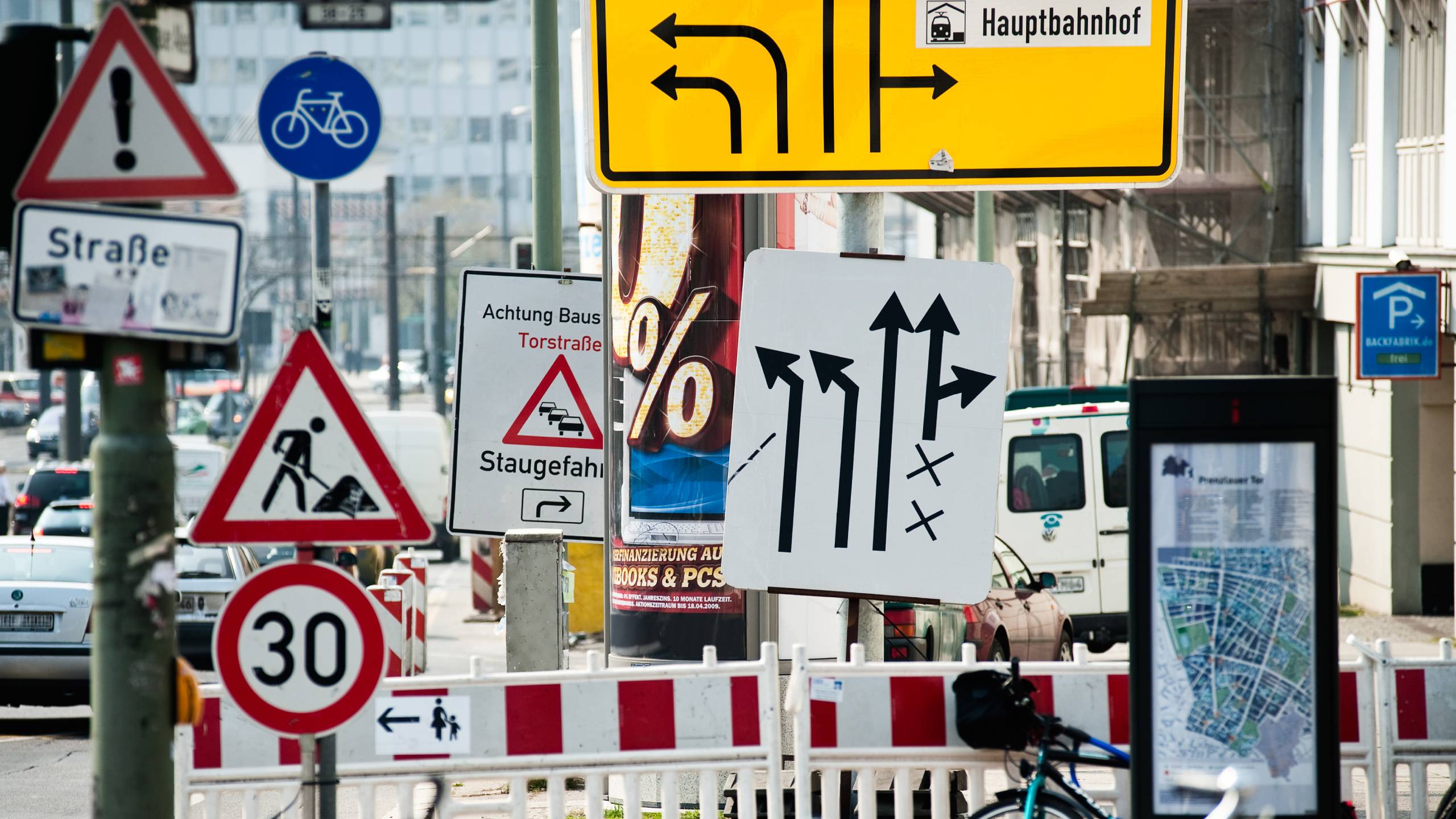 On the side of a busy road in a major European city there are so many road signs close together that you completely lose track of what is allowed and what is not